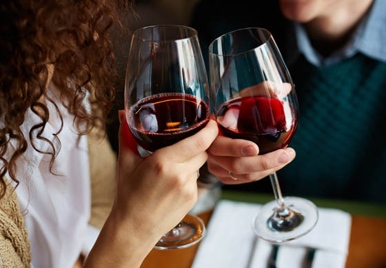 Couple enjoying glasses of red wine